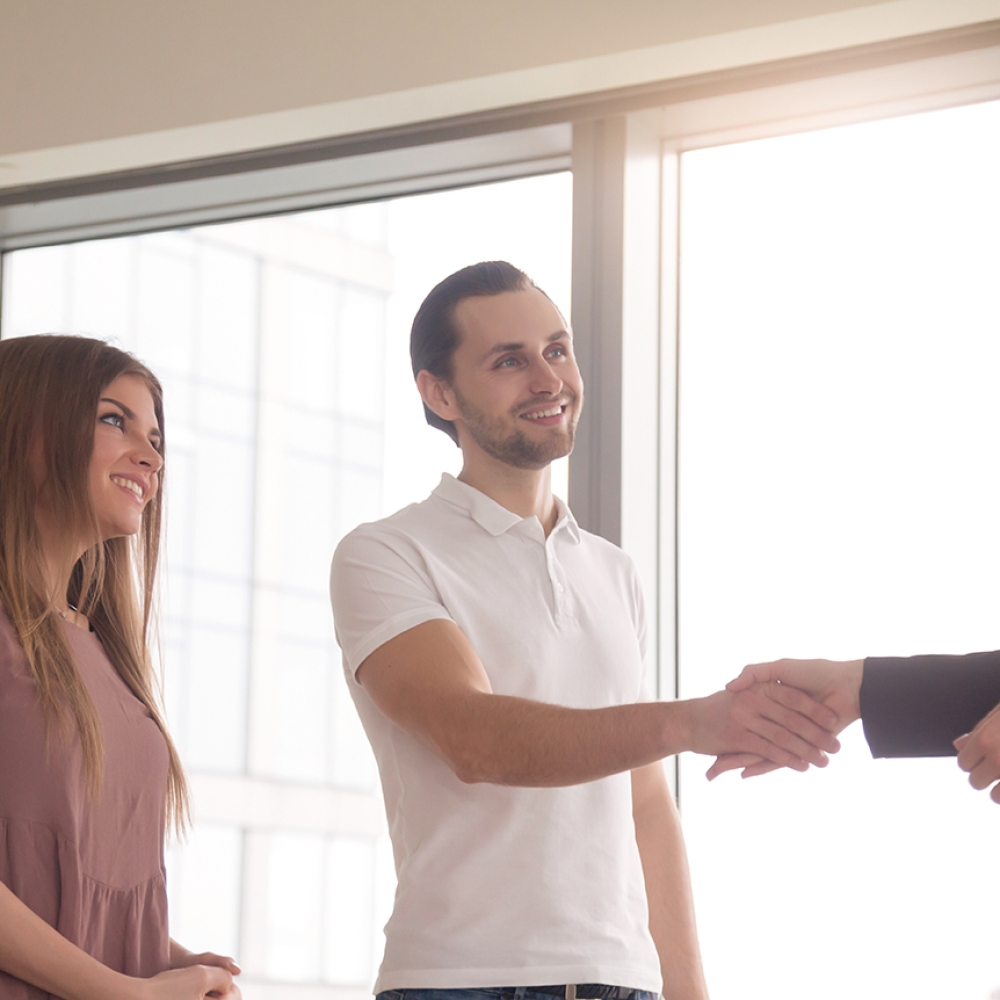 Man and woman came to the office to get consultation. Business people shaking hands, before after successful negotiations, pleasant meeting with agent, notary or lawyer, greeting gesture